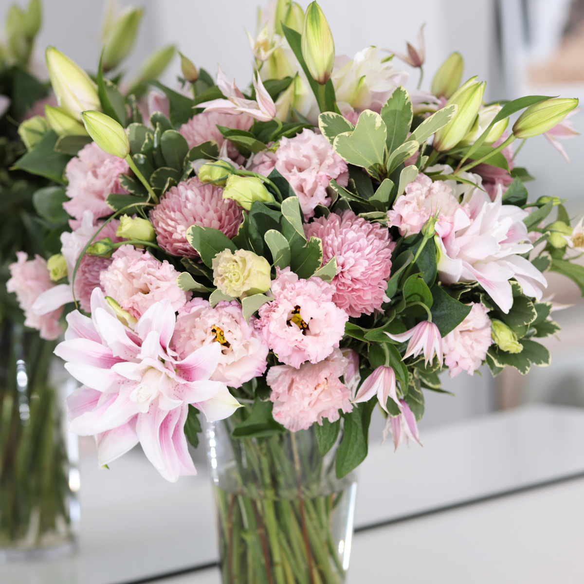The Aetheria by Eos Blooms: double lilies in a clear vase for a romantic, manor-garden look.