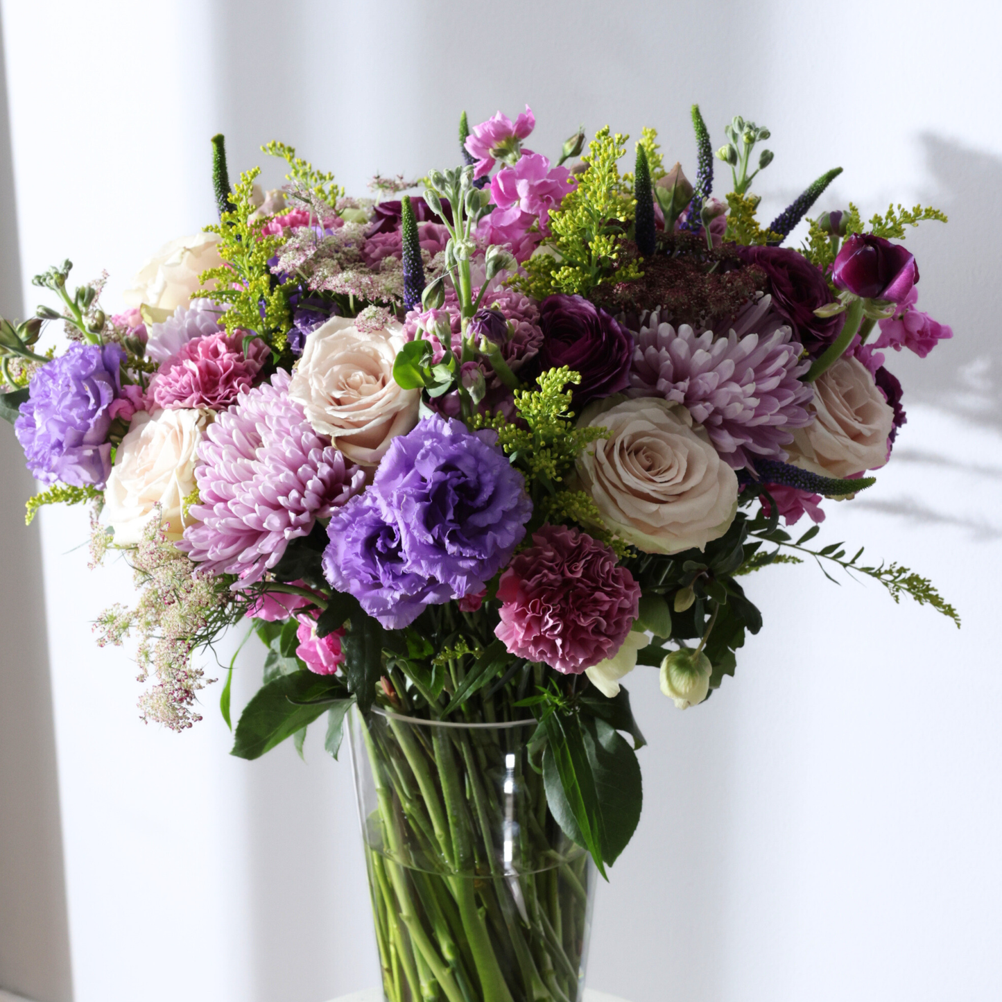 The Condesa | Hotel Guest by Eos Blooms: glass vase with sand roses & lavender lisianthus.