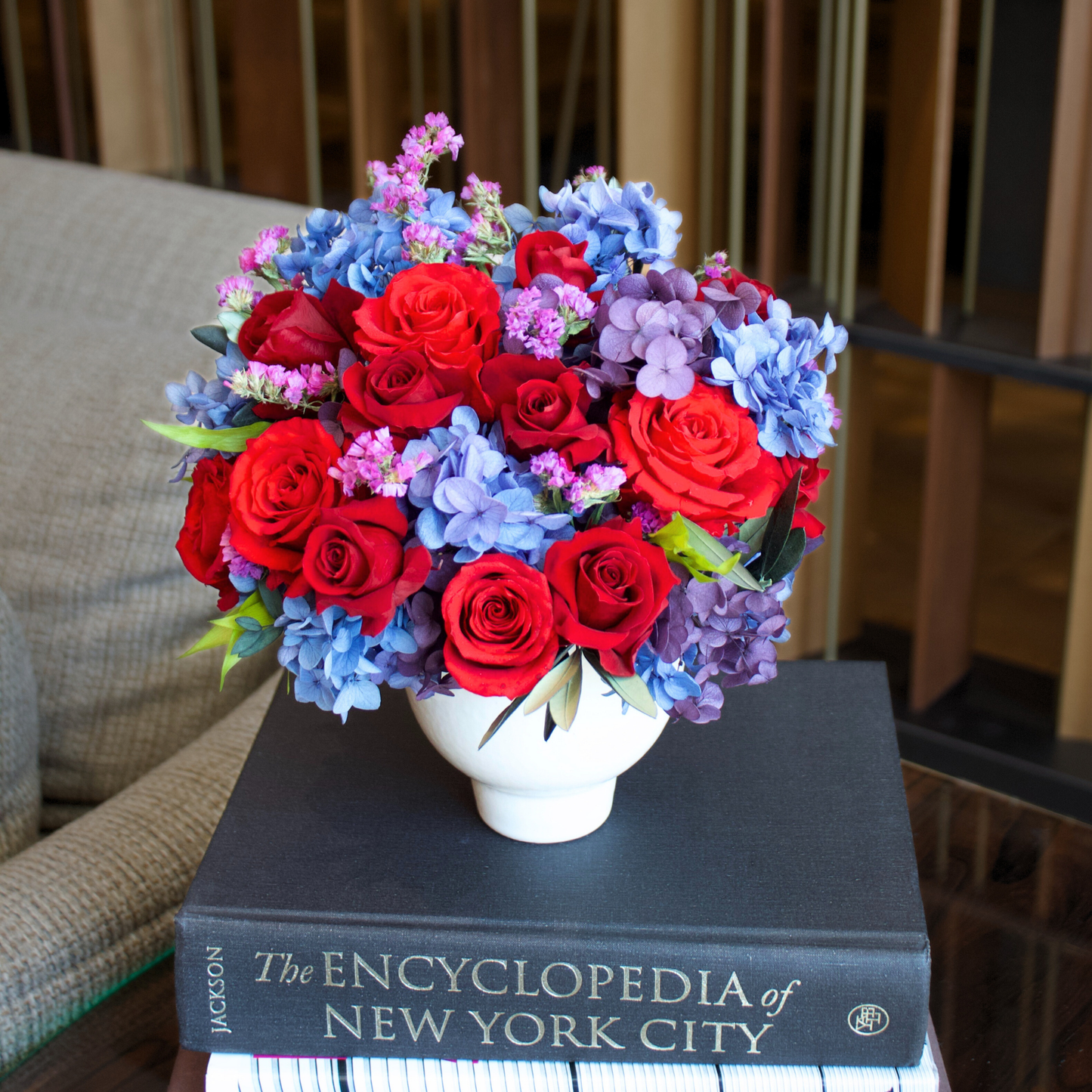The Bijoux (Petite) by Eos Blooms: Forever Roses & purple blooms in a vase on NYC Encyclopedia.