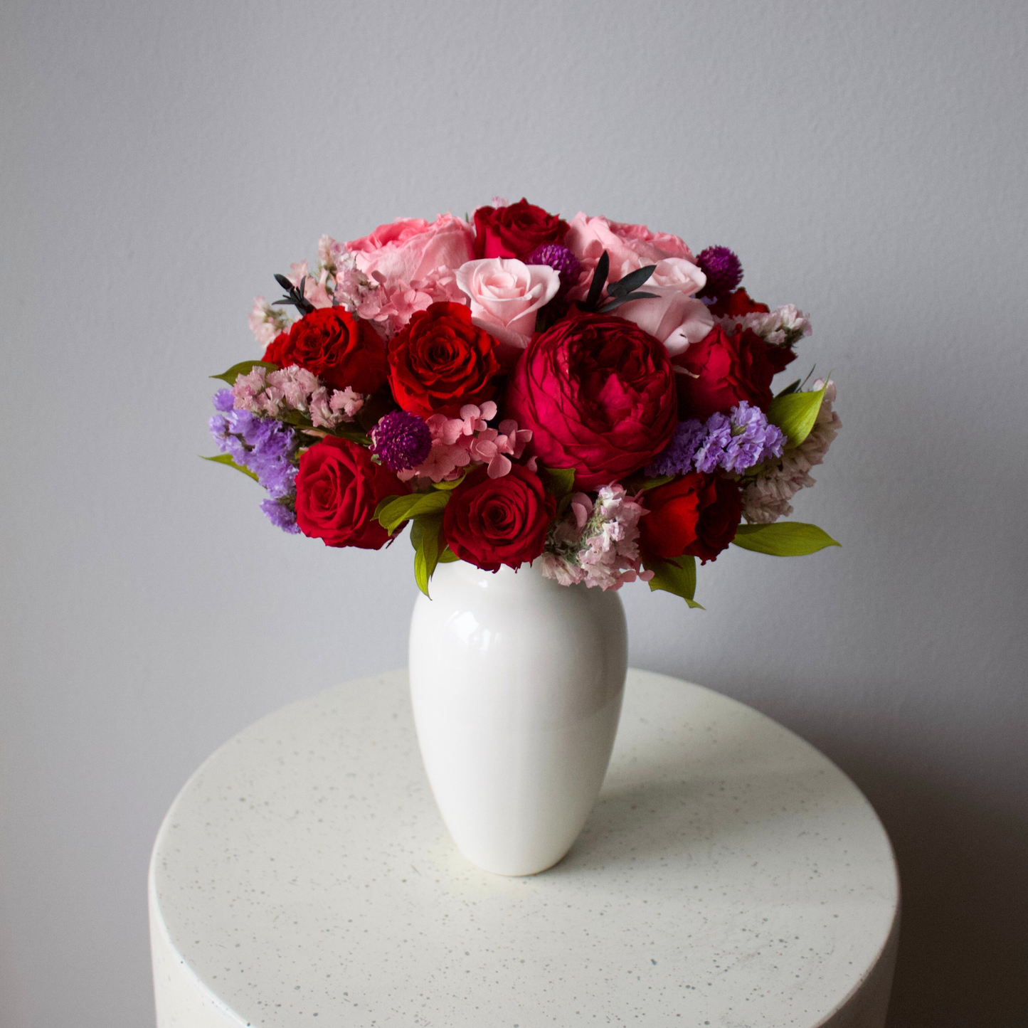 Ma Chérie (Petite) by Eos Blooms: a white vase with preserved flowers on a round table.