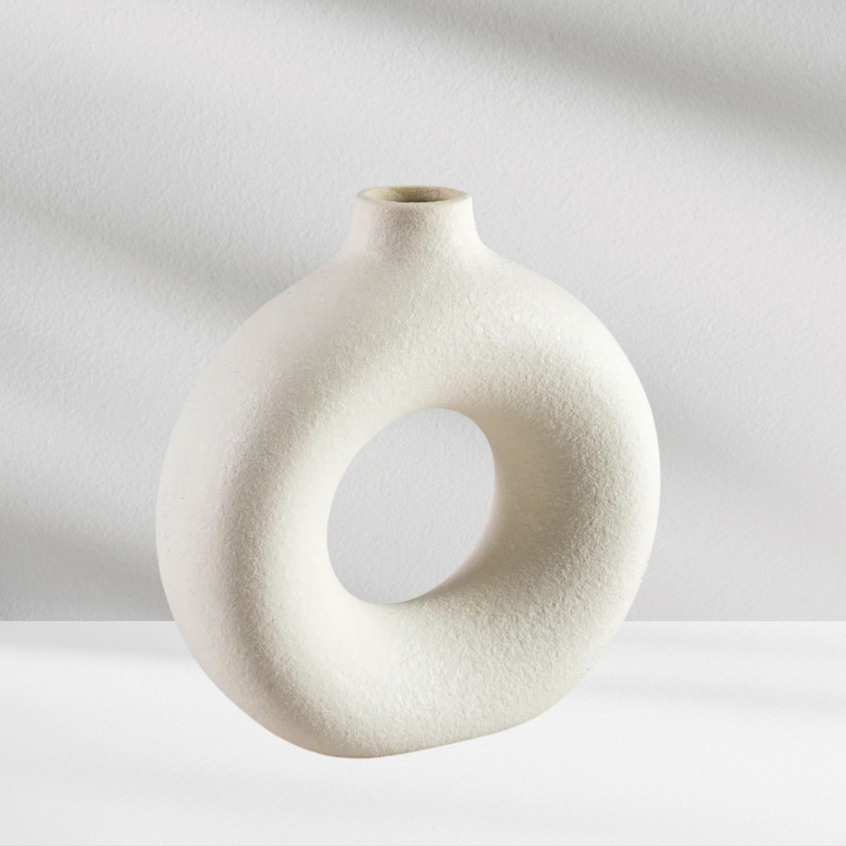 The Copenhagen Vase by Eos Blooms features a round, hollow ceramic design with a textured finish.