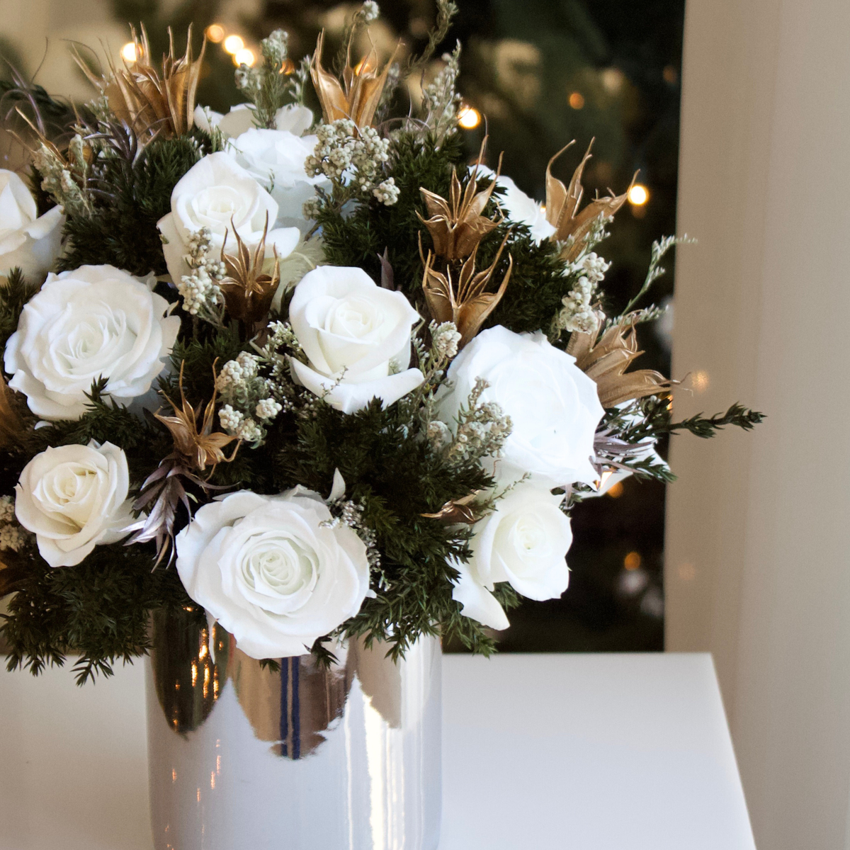 The Frost (Petite) by Eos Blooms brings elegant preserved roses in a shiny silver vase.