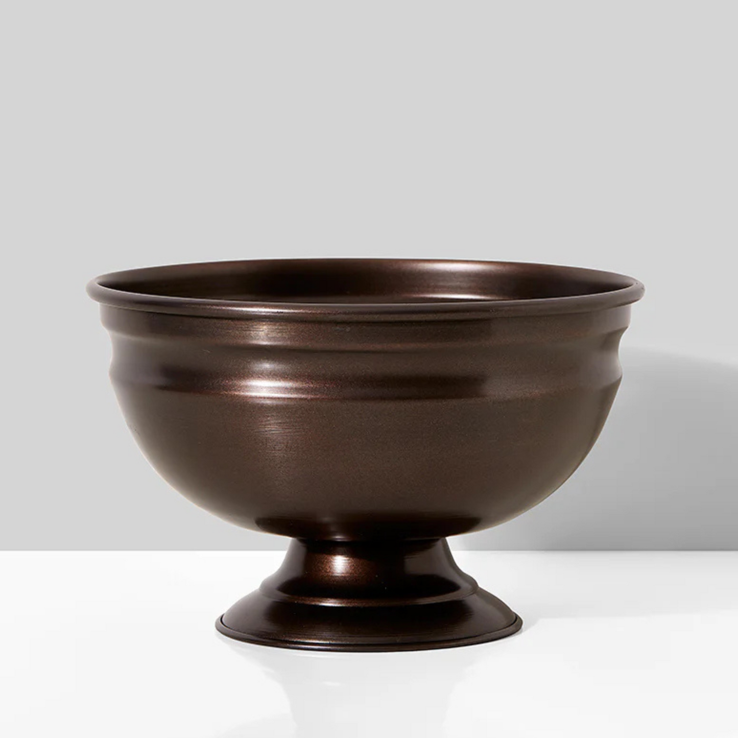 Eos Blooms Antique Copper Pedestal on a white surface with a gray background.