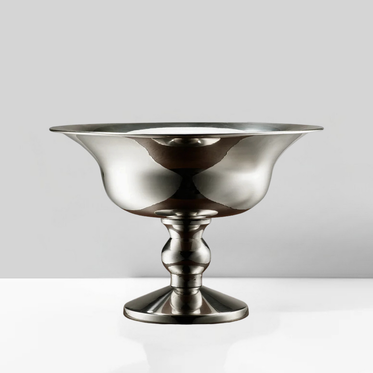 The Eos Blooms Polished Nickel Pedestal sits on a white surface with a gray background.