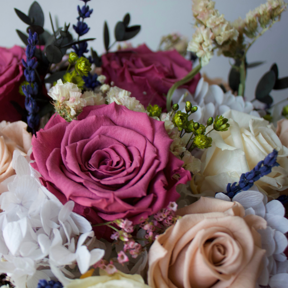 A close-up of The Après by Eos Blooms, a luxury floral arrangement with roses and assorted flowers.