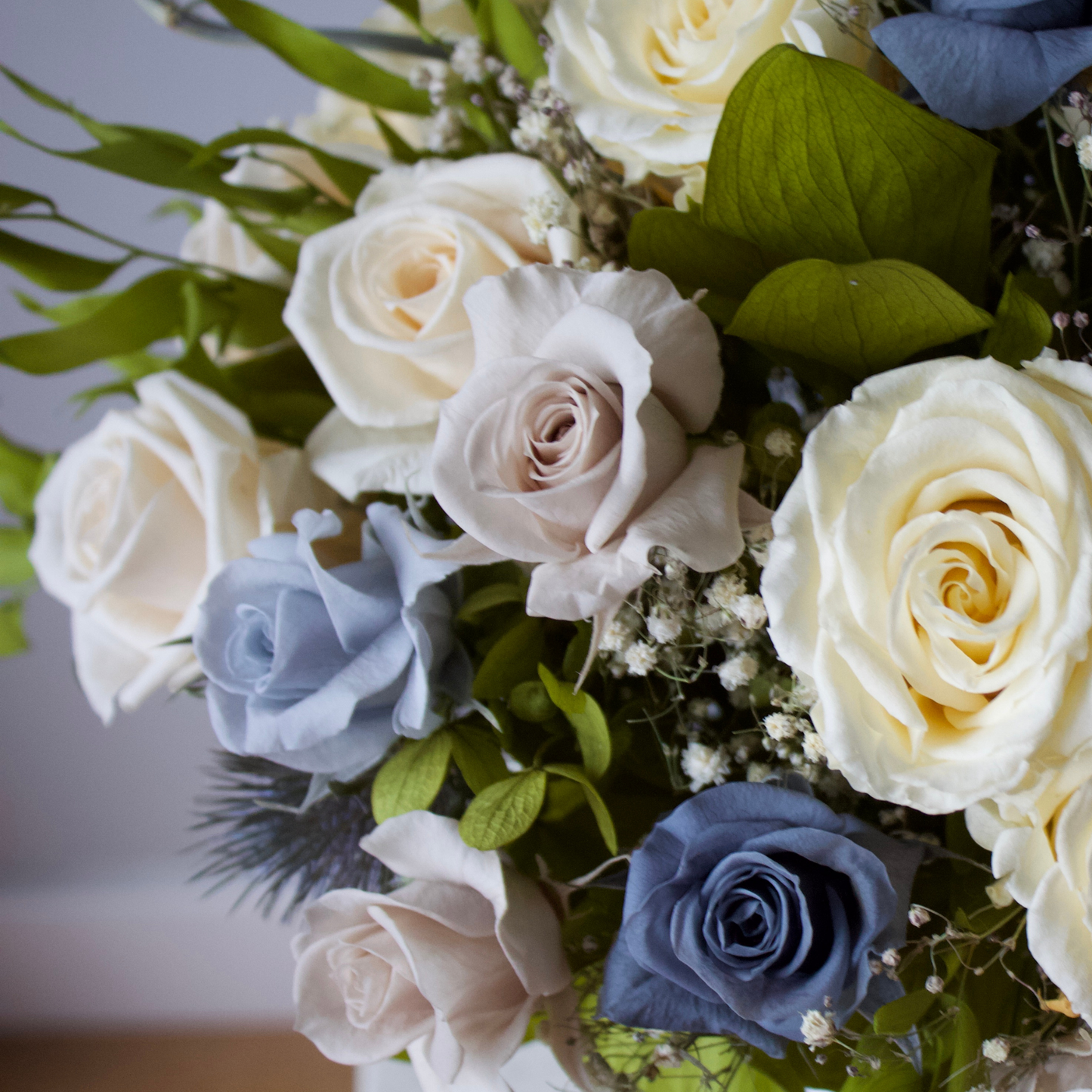 The Nantucket (Petite) by Eos Blooms: preserved cream, blue & lavender roses with baby's breath.