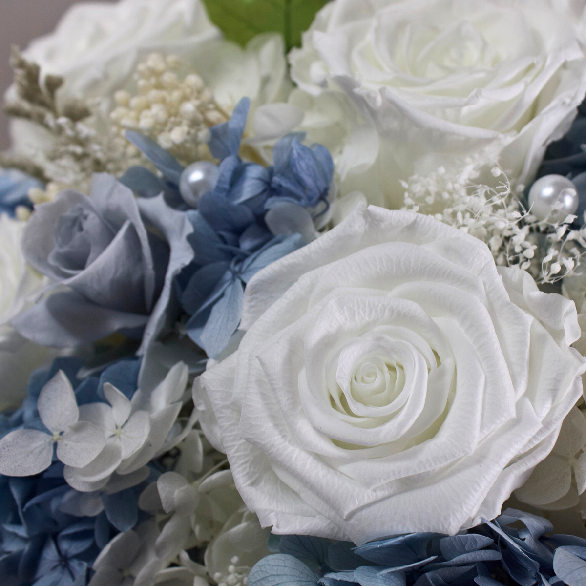 Riviera Privé by Eos Blooms: white roses and blue hydrangeas with pearls in a graceful bouquet.