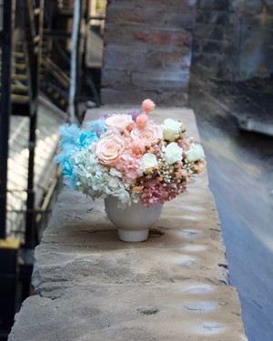The Aquarella (Petite) by Eos Blooms: pastel preserved florals in a white vase on a stone ledge.