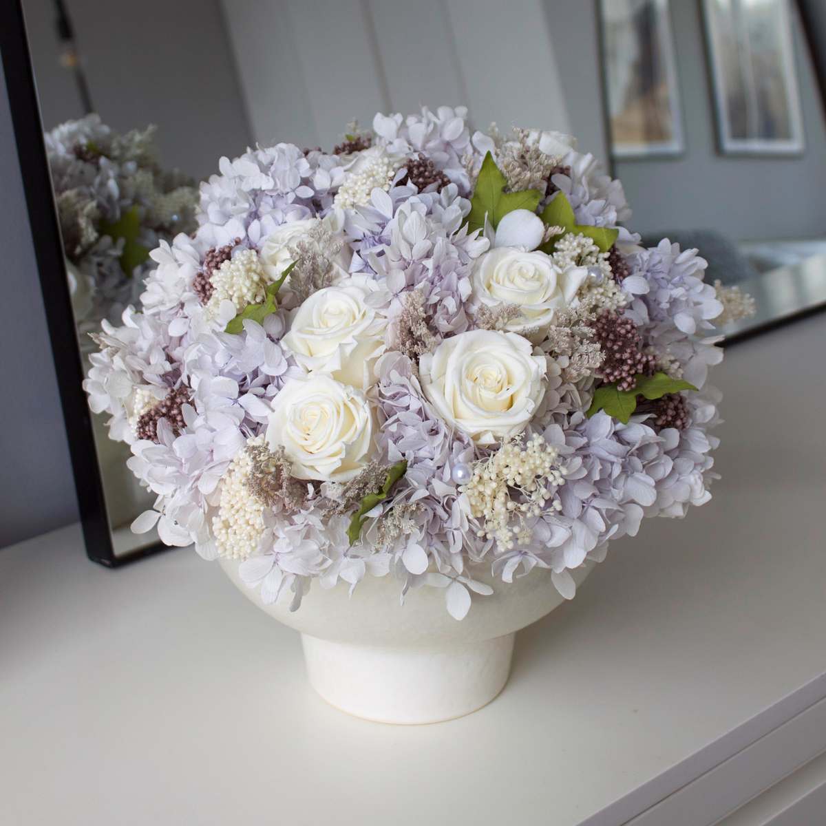 Riviera Privé by Eos Blooms: white roses, hydrangeas & pearls in a vase on a white table.
