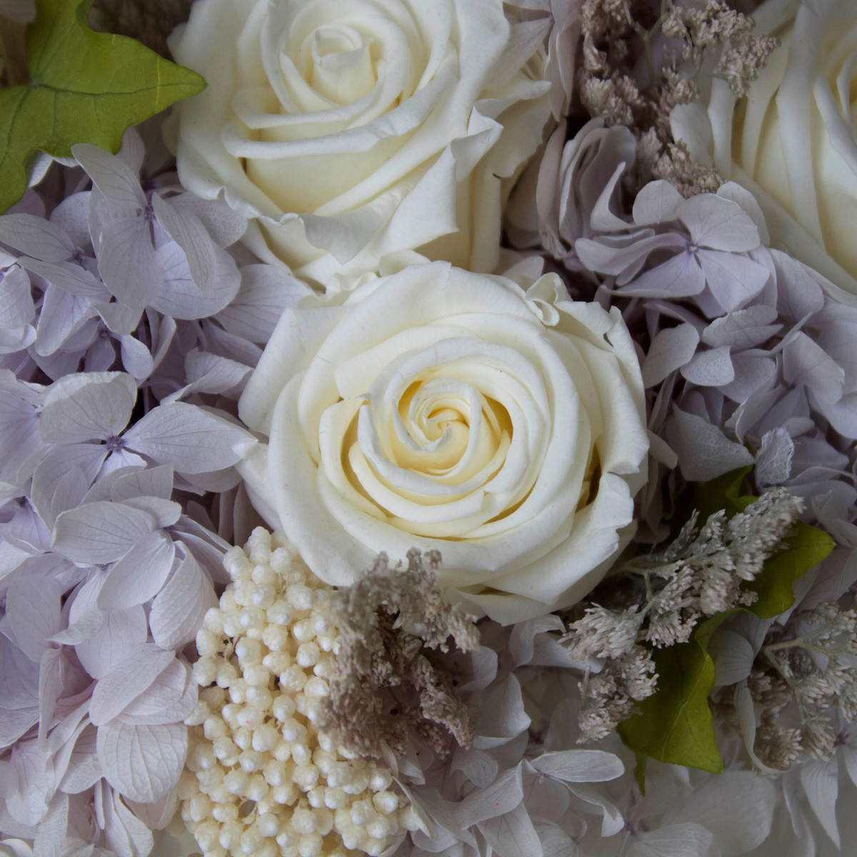 Riviera Privé by Eos Blooms: white roses, light purple hydrangeas, berries & pearls.