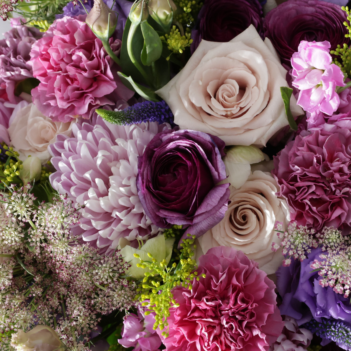 A close-up bouquet of pink and purple flowers.