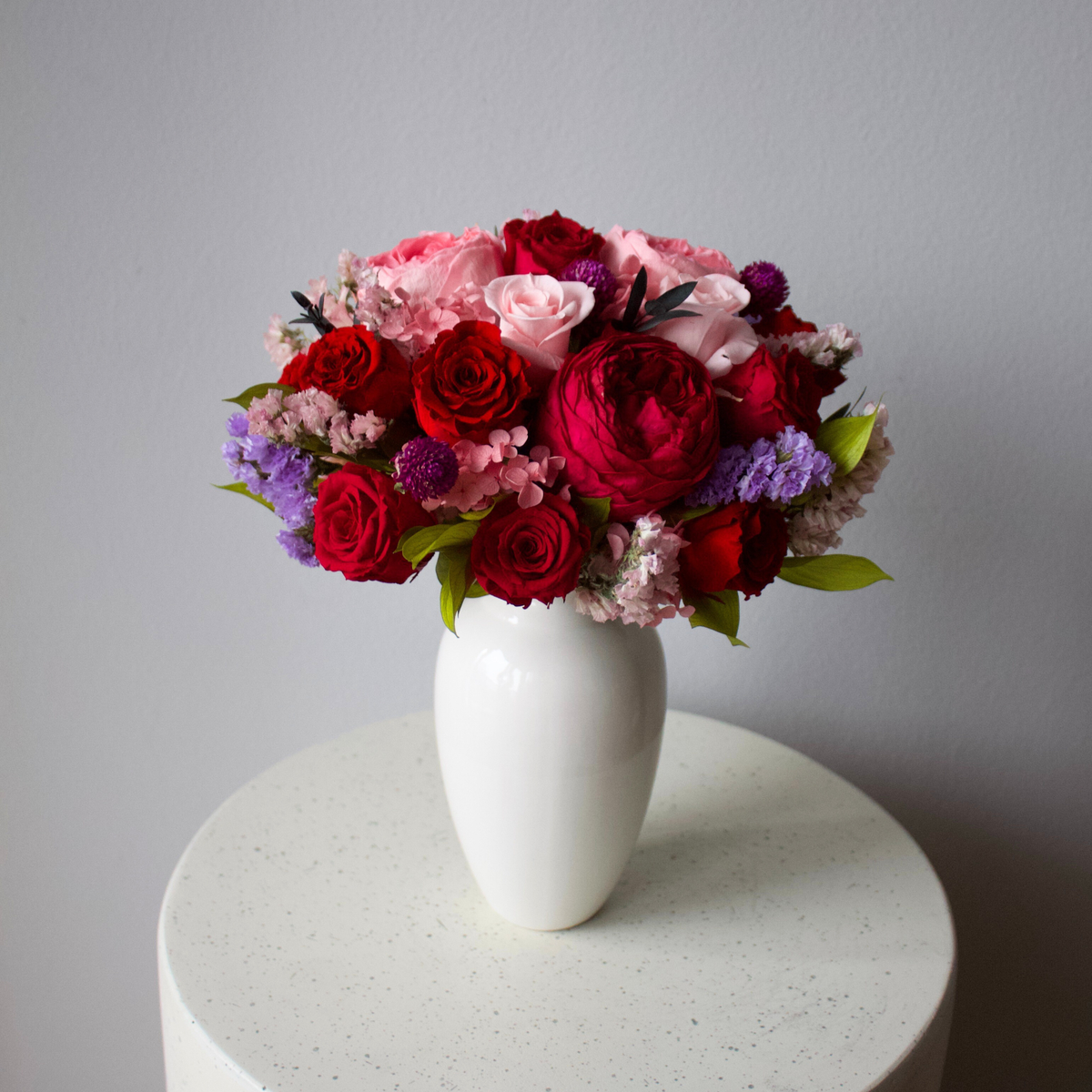 Ma Chérie (Petite) by Eos Blooms: a white vase with preserved flowers on a round table.