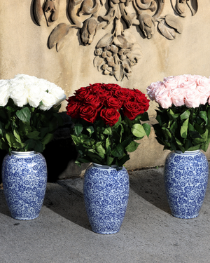 The Amalia by Eos Blooms: three azulejos vases with preserved white, red, and pink roses.