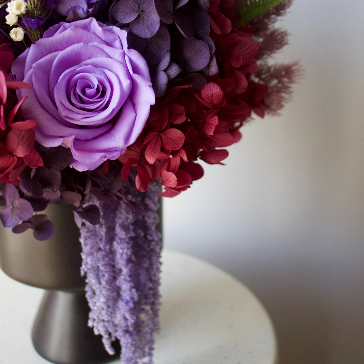 Ultraviolet by Eos Blooms: a petite bouquet with Forever Roses, red hydrangeas, and lavender.