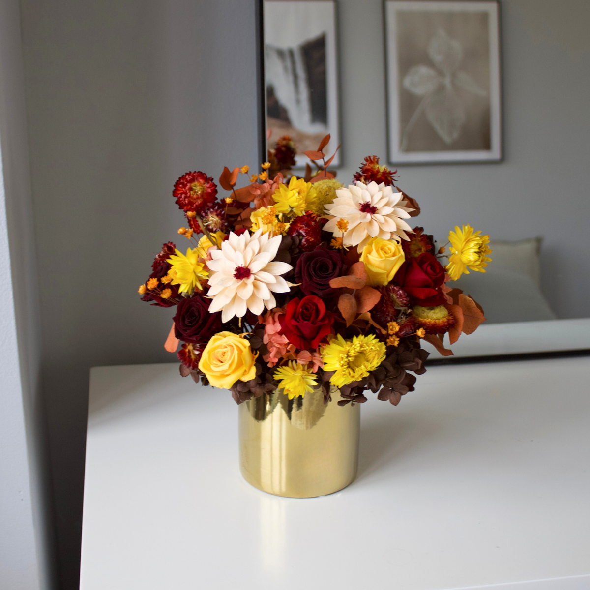 Golden Hour (Petite) by Eos Blooms: a gold vase with red, yellow, and white preserved florals.