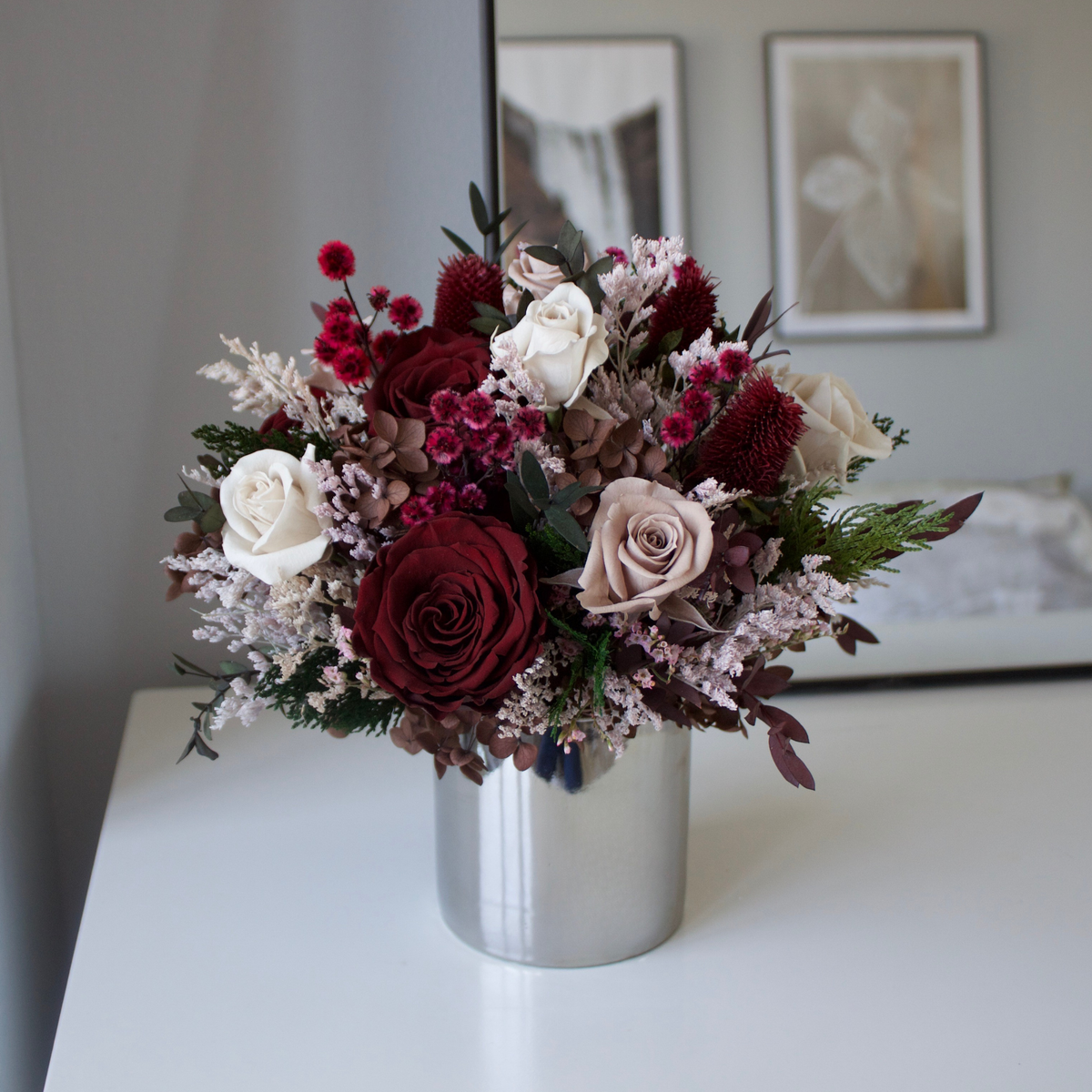 Eos Blooms' Midnight Forest (Petite) sits in a silver vase on a white table.