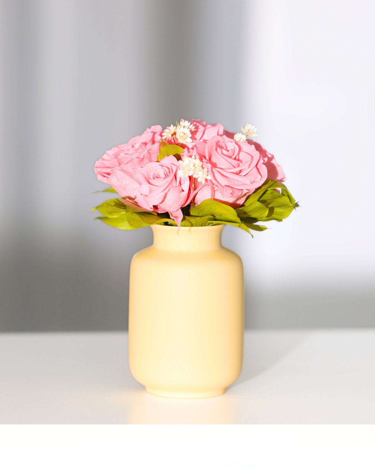 Eos Blooms’ Mini Milk Jars display pink roses and white flowers on a white surface.
