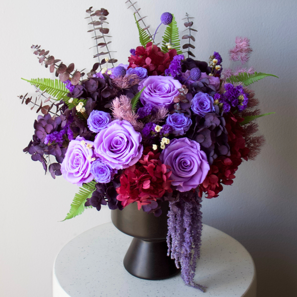 Eos Blooms' Preserved Flower Subscription: forever blooms delivered nationwide in a black vase.