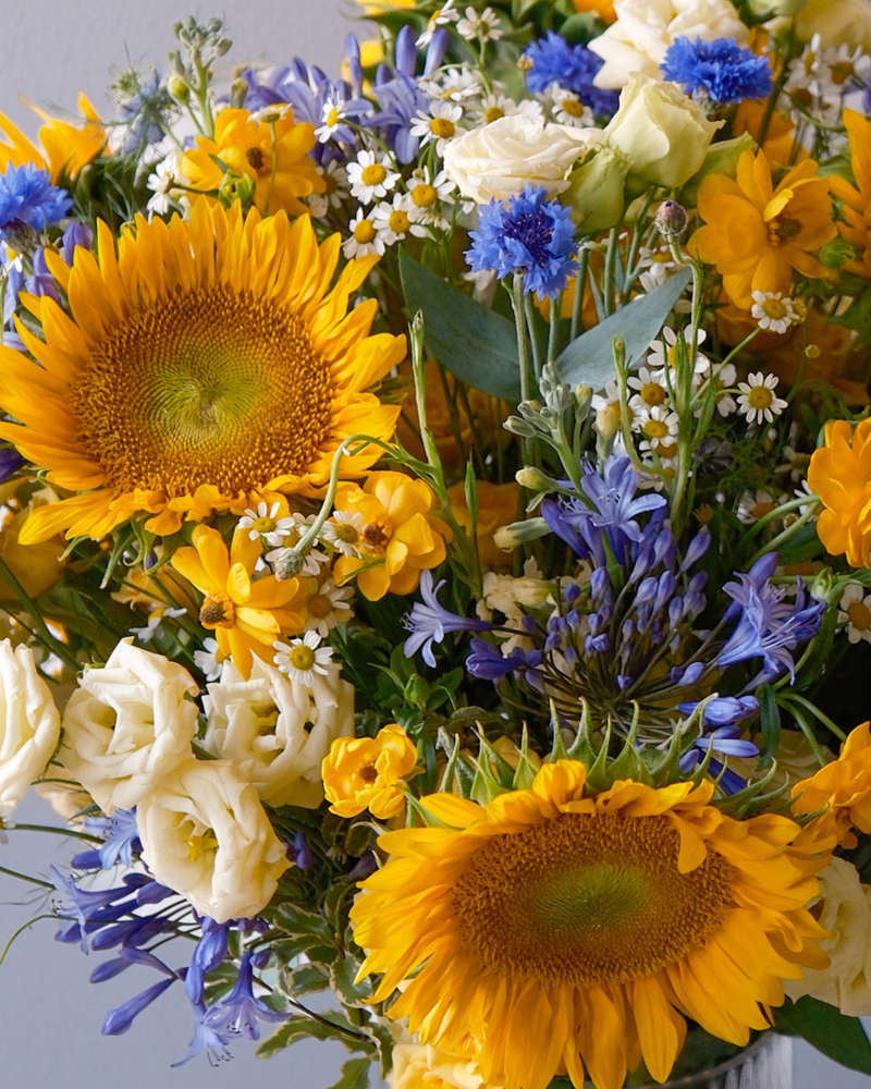 The Starry Night by Eos Blooms: sunflowers, farm-fresh blue and white blooms, and greens.