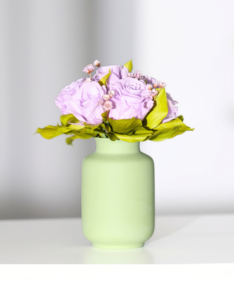 Mini Milk Jars by Eos Blooms: light purple preserved blooms with greenery in a ceramic jar.