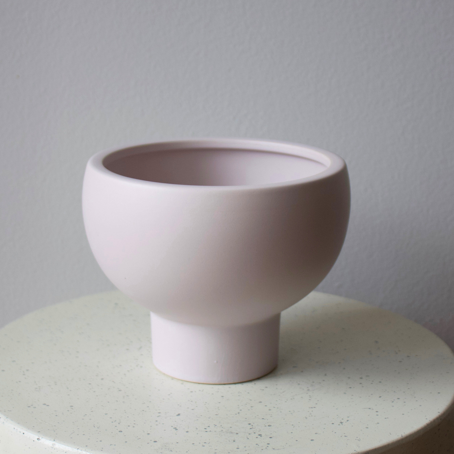 The Lyon Pedestal by Eos Blooms: a matte pale pink bowl with a classic footed-vase design.