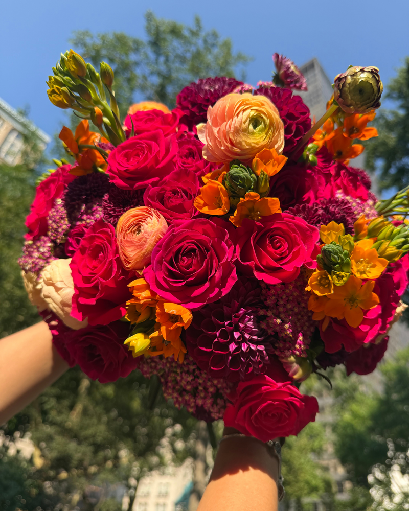 Hands holding The Leo ♌ by Eos Blooms, a sunny day birthday gift for Leos.