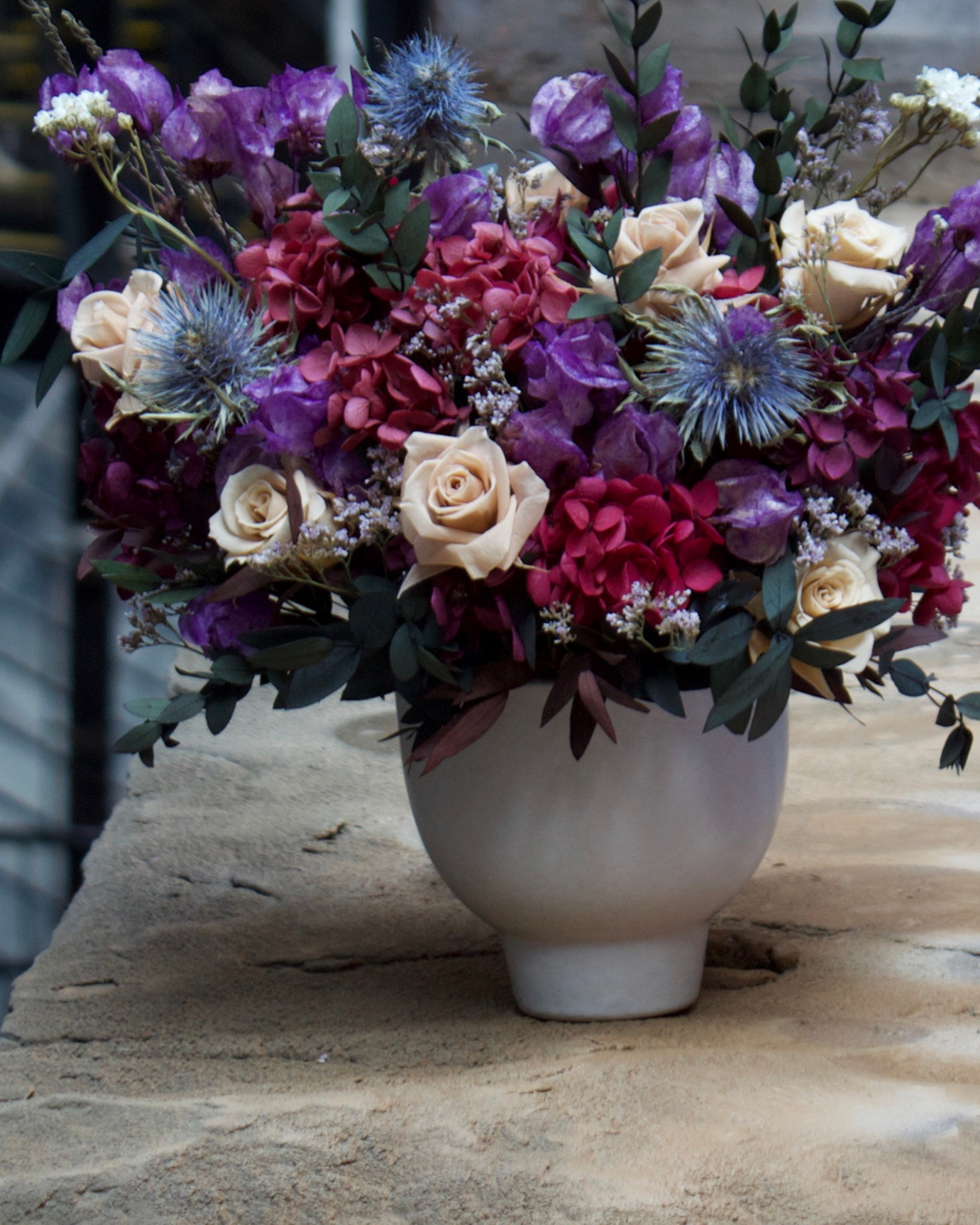 The Vinter (Petite) by Eos Blooms: white vase with pink, purple & cream preserved flowers.