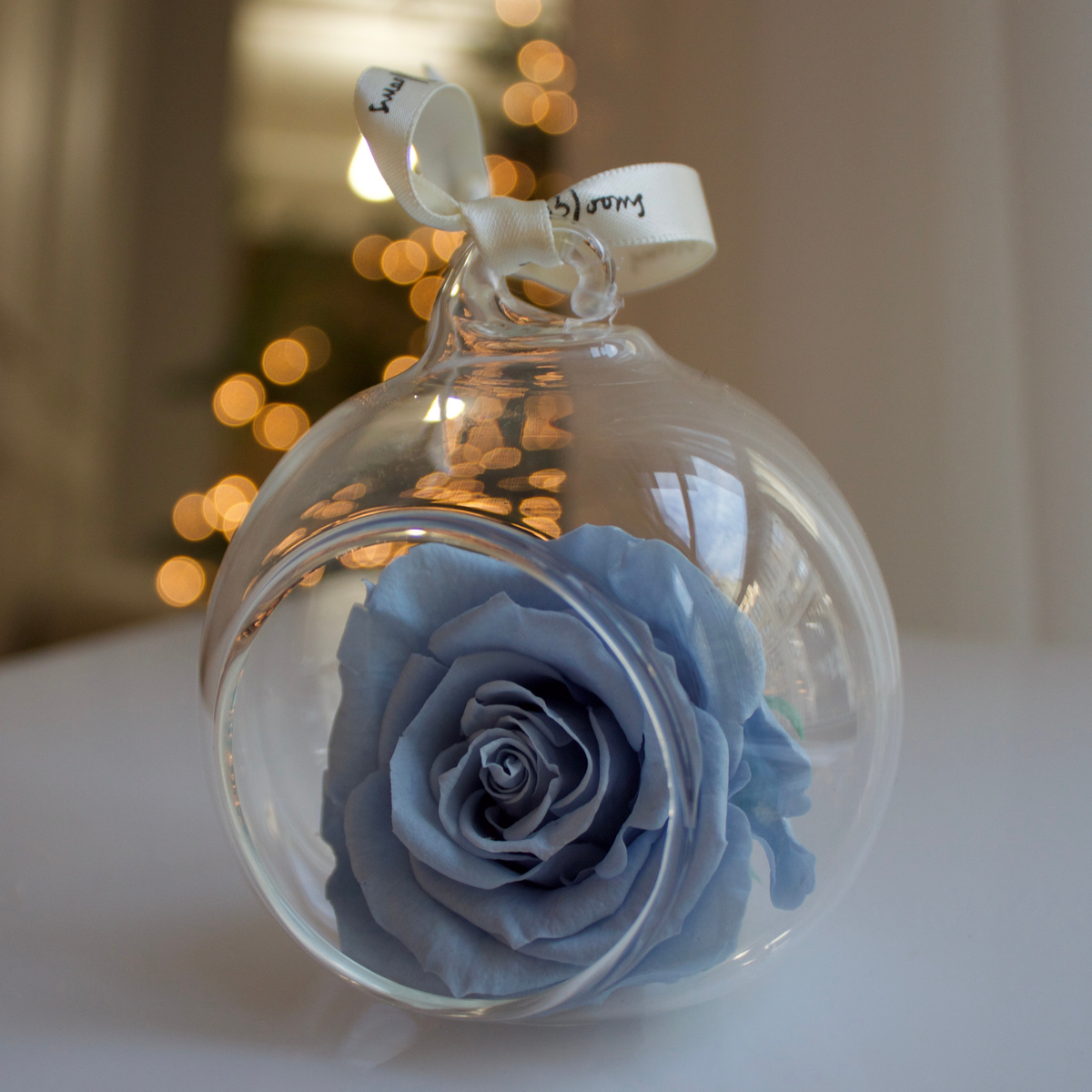 Eos Blooms Glass Ornaments 4-Pack: Blue preserved rose in clear glass with white ribbon.