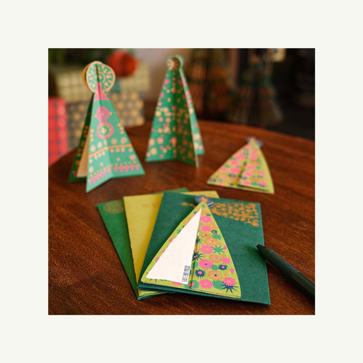 Hand-Illustrated Greeting Cards by Eos Blooms, inspired by trees, displayed on a table.