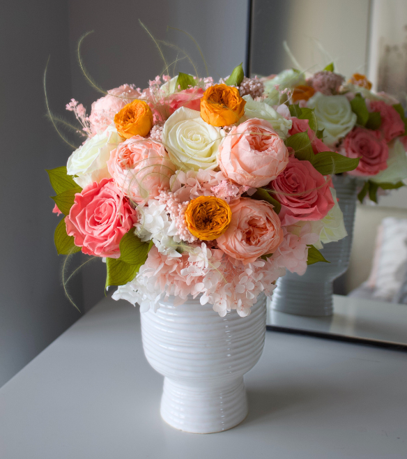 Eos Blooms’ Preserved Flower Subscription: pink, white & orange forever blooms in a white vase.