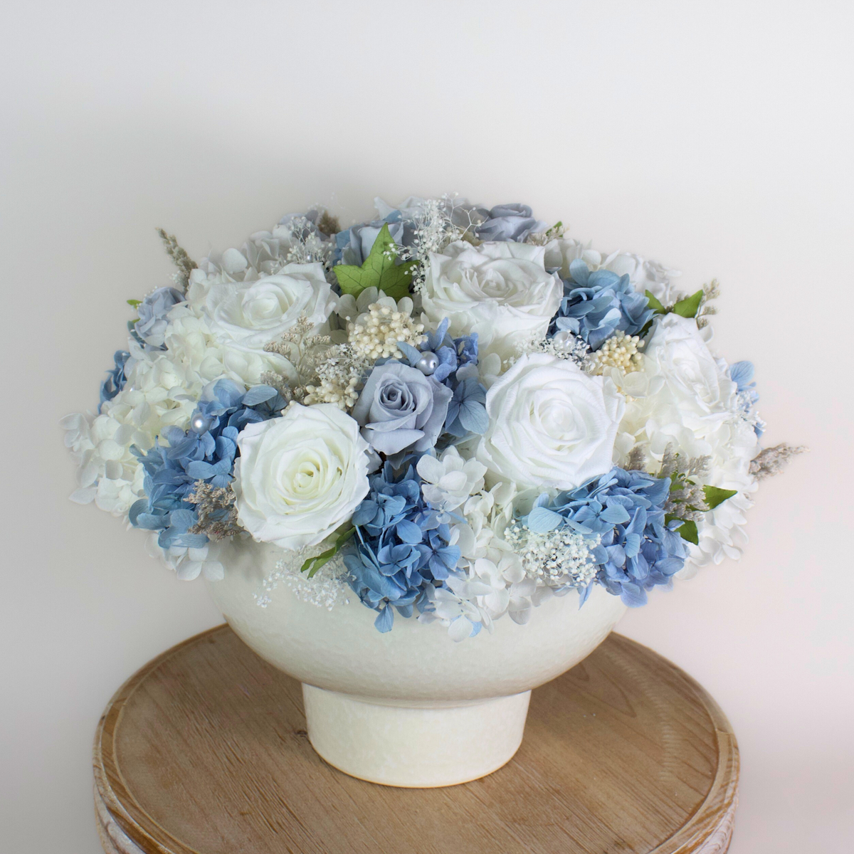 Riviera Privé by Eos Blooms: white hydrangeas and roses with pearls in a bowl.
