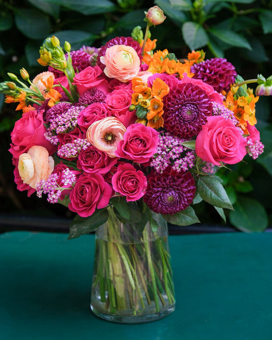 The Leo by Eos Blooms: vibrant pink roses and orange flowers—ideal birthday or Leo gift.