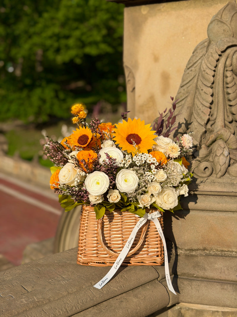 The Orchard | Autumn Basket by Eos Blooms—sunflowers, roses, and whites for autumn decor.