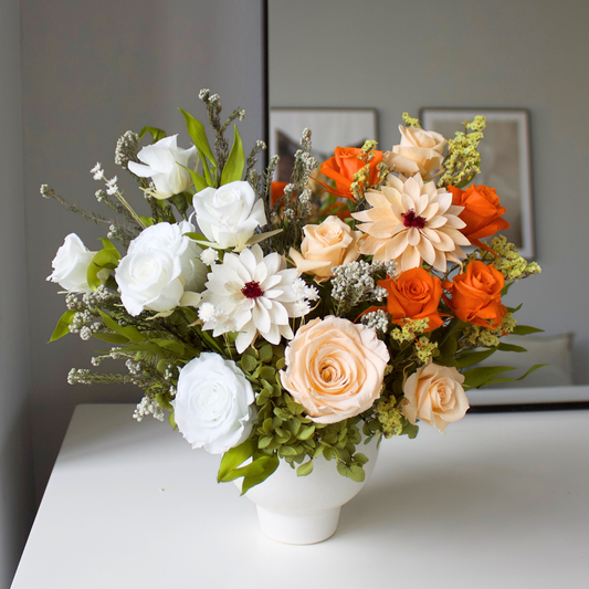 The Afterglow (Petite) by Eos Blooms features preserved white, peach, and orange blooms in a vase.