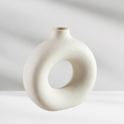 The Copenhagen Vase by Eos Blooms features a round, hollow ceramic design with a textured finish.