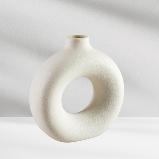 The Copenhagen Vase by Eos Blooms features a round, hollow ceramic design with a textured finish.
