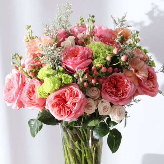 The Bon Bon | Hotel Guest by Eos Blooms: candy-pink roses, green & white blooms in glass vase.