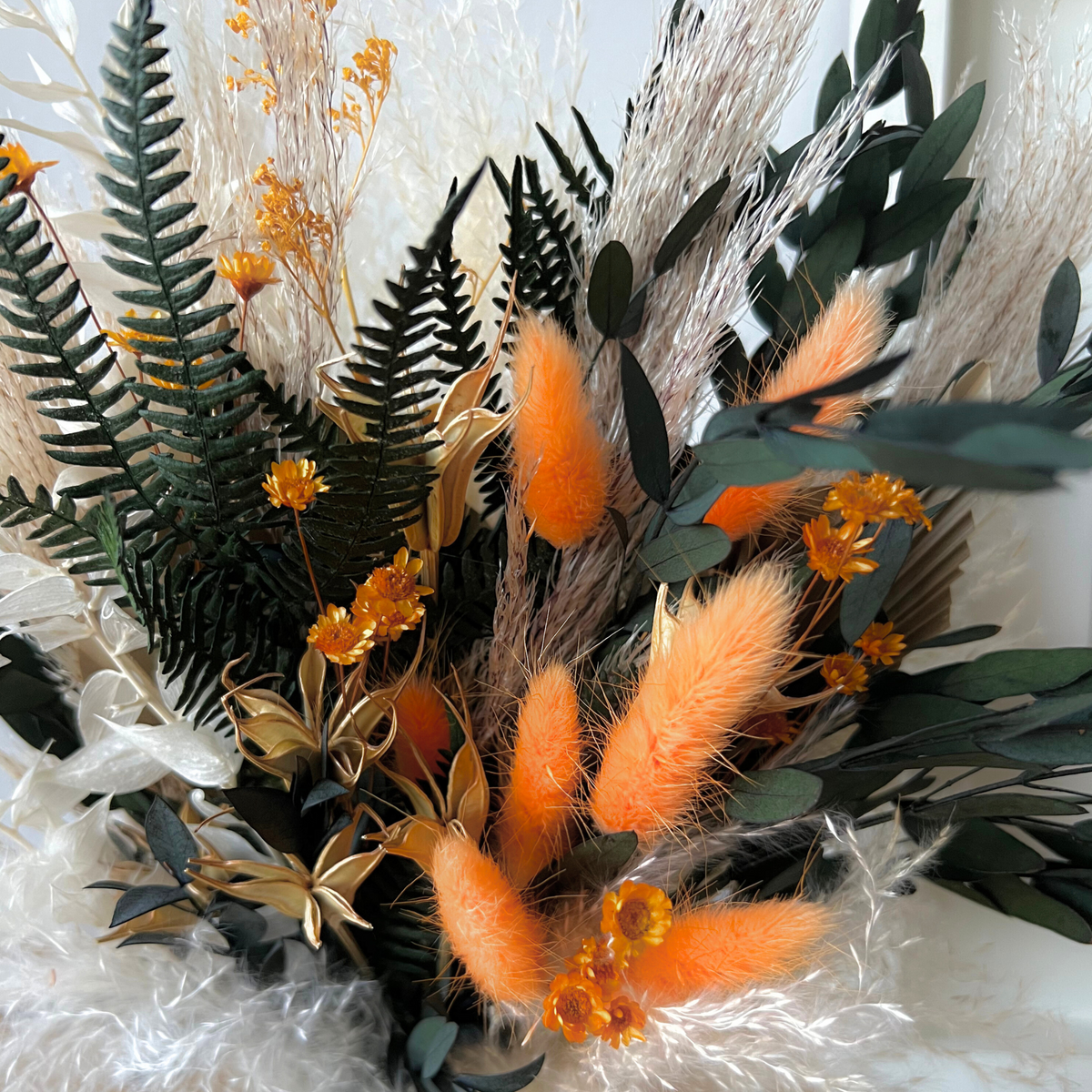 The "Harvest" bouquet by Eos Blooms features dried ferns, grasses, and preserved flowers.