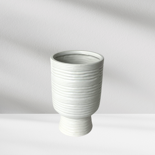 Paz Vase by Eos Blooms, ribbed ceramic with horizontal lines on a white surface.