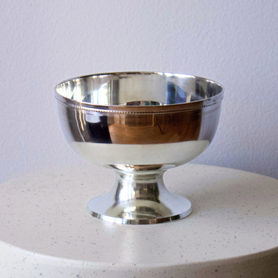 Eos Blooms Silver Pedestal bowl shines on a light surface, ideal as a table centrepiece.