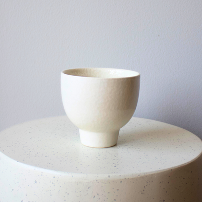 The Eos Blooms Small White Pedestal stands on a round base against a plain background.