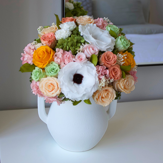 The Encanto by Eos Blooms features luxe roses and preserved blooms in a white vase.