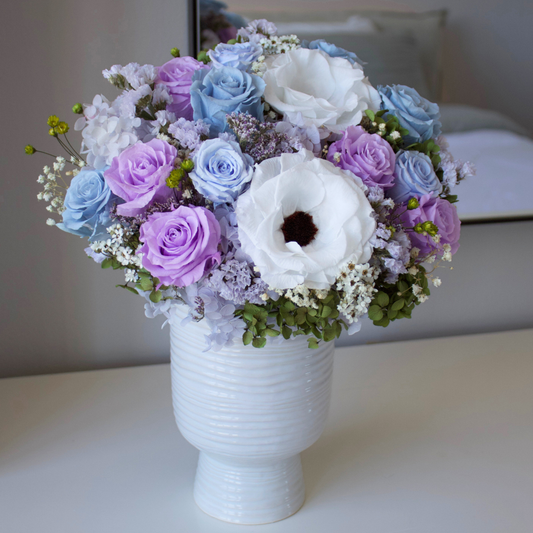 The Giverny by Eos Blooms: white vase with Forever Roses & blue blooms, Monet-inspired.