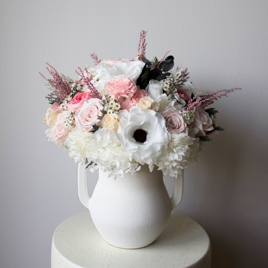 The Gossamer by Eos Blooms: White vase with pink, white & lilac preserved Forever Flowers.
