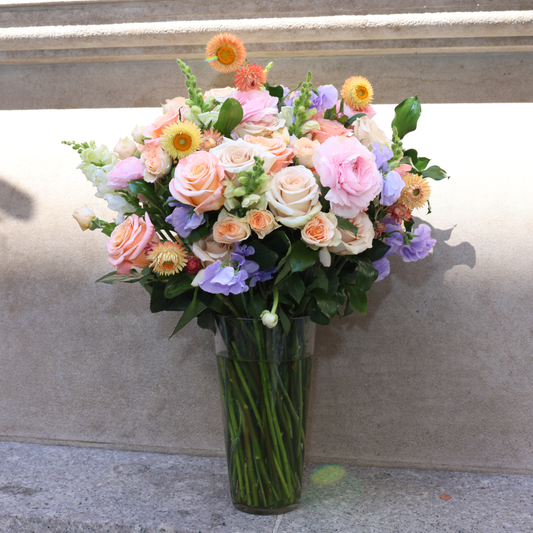 The Highnoon by Eos Blooms: tall pastel blooms with apricot roses & daisies.