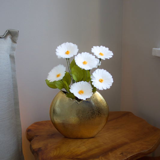 The Margarita | Preserved Daisies by Eos Blooms on a wooden table in a softly lit corner.