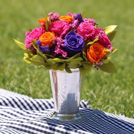The Mariposa (Mini Julep) by Eos Blooms on striped cloth, outdoors on grass.