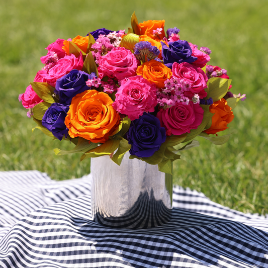 The Mariposa (Petite) by Eos Blooms on striped cloth outdoors.