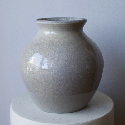 The Tulum Vase by Eos Blooms—a large, glossy ceramic vase on a white surface and gray wall.