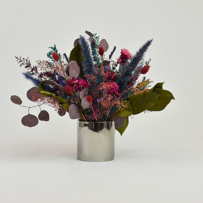 Tropics by Eos Blooms: vibrant preserved flowers in a silver vase for a lasting modern look.
